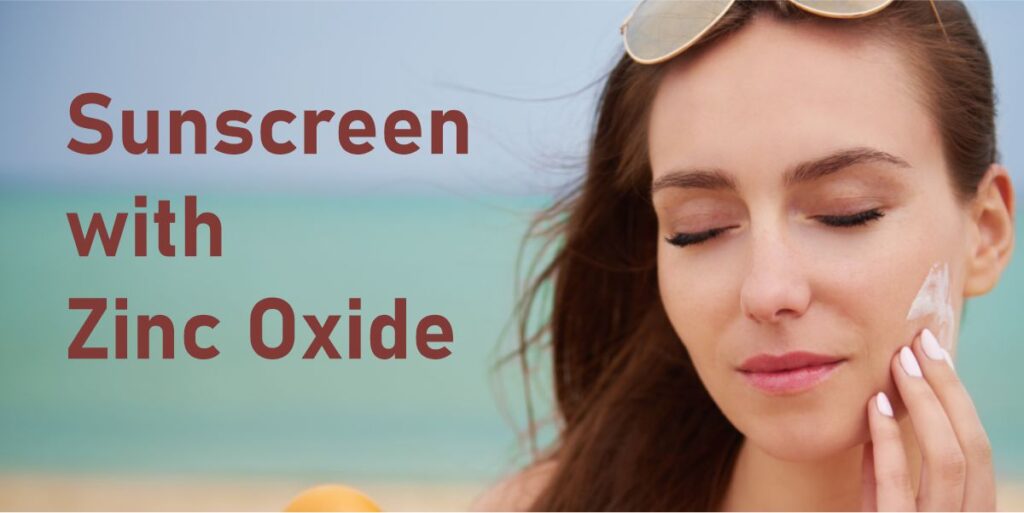 image of a woman rubbing sunscreen on her cheek